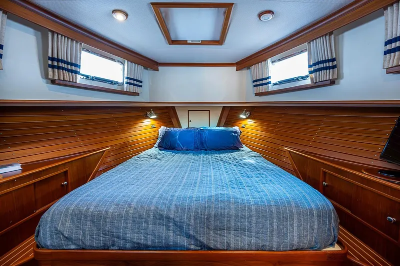 Slide: The Image of Luxurious cabin interior of 2002 Grand Banks 42 Europa yacht with cozy bedding. - 43