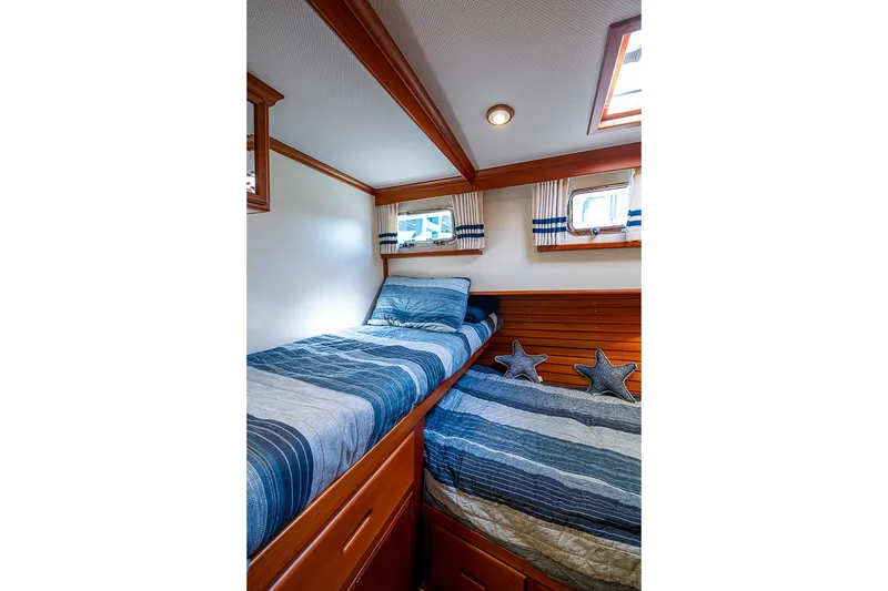 Slide: The Image of Cozy twin cabin with striped bedding in 2002 Grand Banks 42 Europa yacht. - 47