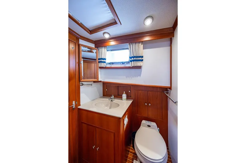 Slide: The Image of Luxurious bathroom in 2002 Grand Banks 42 Europa yacht with wood accents and modern fixtures. - 48