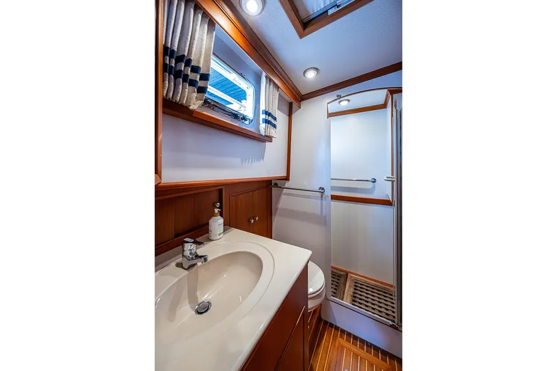 Slide: The Image of Luxurious bathroom interior of 2002 Grand Banks 42 Europa yacht with wood accents and modern fixtures. - 49