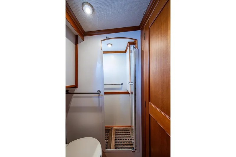 Slide: The Image of Bathroom interior of 2002 Grand Banks 42 Europa yacht, featuring wooden accents and modern fixtures. - 50