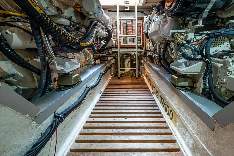 Slide: The Image of Engine room of 2002 Grand Banks 42 Europa yacht, showcasing mechanical components and wiring. - 53