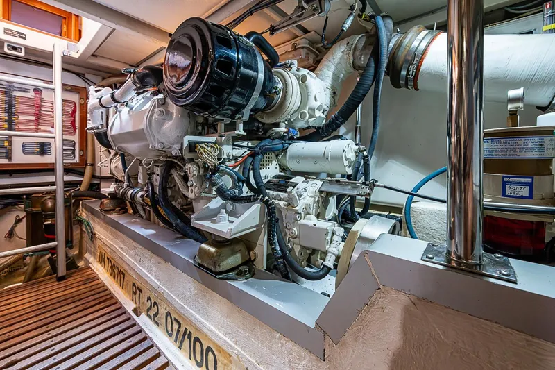 Slide: The Image of Engine room of 2002 Grand Banks 42 Europa yacht, showcasing detailed mechanical components. - 54