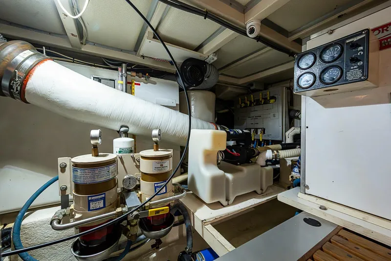 Slide: The Image of Engine room of 2002 Grand Banks 42 Europa yacht, featuring gauges and mechanical components. - 55