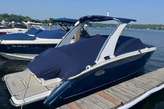 The Image of 2018 Cobalt R5 boat docked, covered with a blue tarp, on a sunny day. - 1