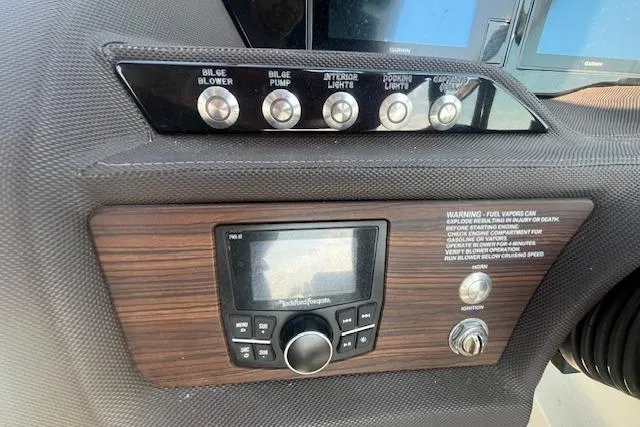 Slide: The Image of Control panel of a 2018 Cobalt R5 boat with switches and a Rockford Fosgate stereo. - 10