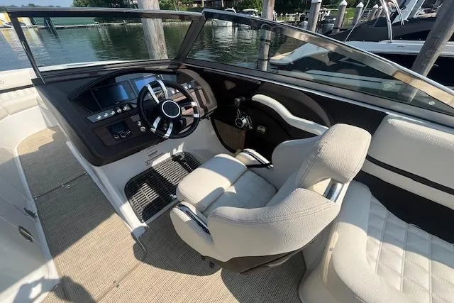 Slide: The Image of Interior of a 2018 Cobalt R5 boat with steering wheel and seating. - 12