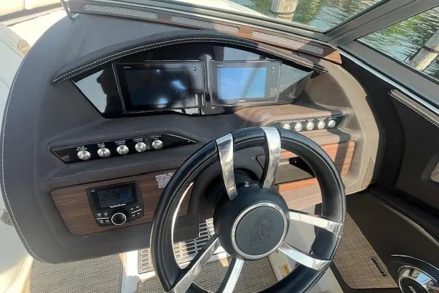 Slide: The Image of Dashboard of a 2018 Cobalt R5 boat with steering wheel and control panels. - 13