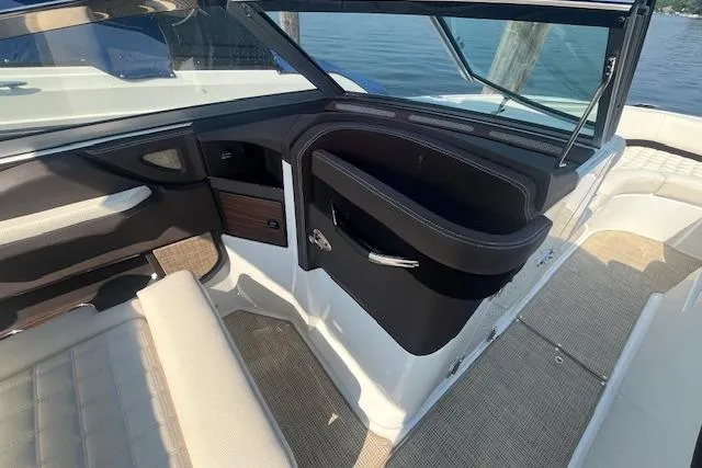 Slide: The Image of 2018 Cobalt R5 boat interior with seating and dashboard, docked by the water. - 15