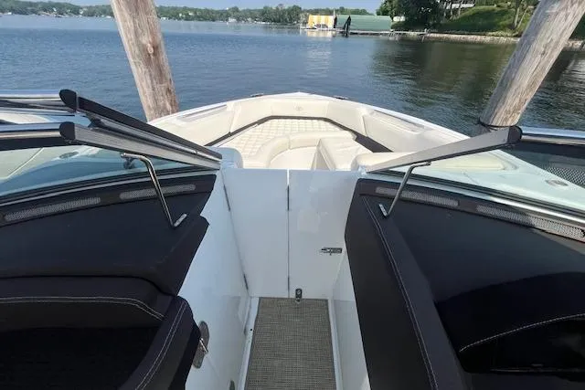 Slide: The Image of 2018 Cobalt R5 boat interior with lake view, featuring sleek seating and open bow design. - 17