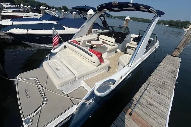 Slide: The Image of 2018 Cobalt R5 boat docked, featuring spacious seating and elegant design. - 3