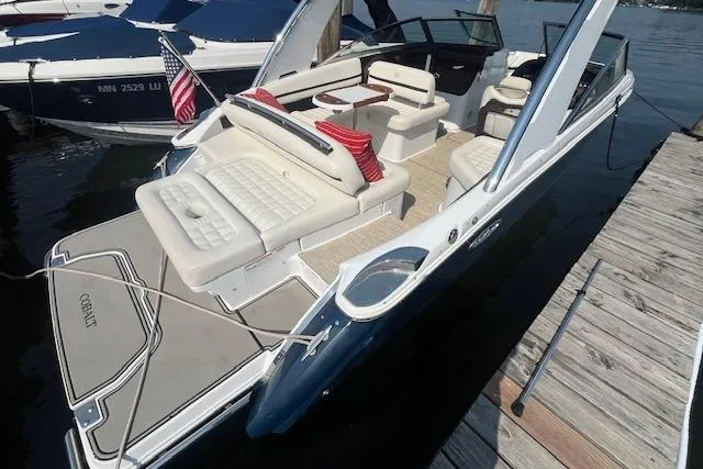 Slide: The Image of 2018 Cobalt R5 boat with spacious seating and American flag, docked on calm water. - 4
