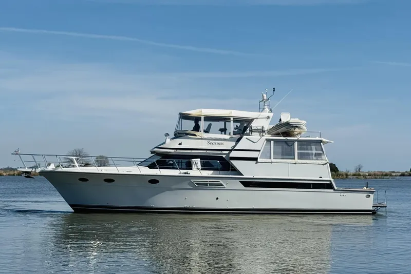 Slide: The Image of 1991 Californian 55 Cockpit Motor Yacht cruising on calm waters under a clear sky. - 10