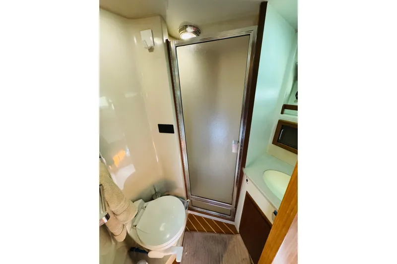 Slide: The Image of Bathroom interior of 1991 Californian 55 Cockpit Motor Yacht with shower and toilet. - 102