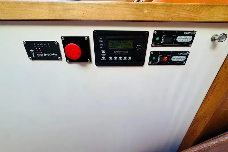 Slide: The Image of Control panel of a 1991 Californian 55 Cockpit Motor Yacht with various electronic displays. - 103
