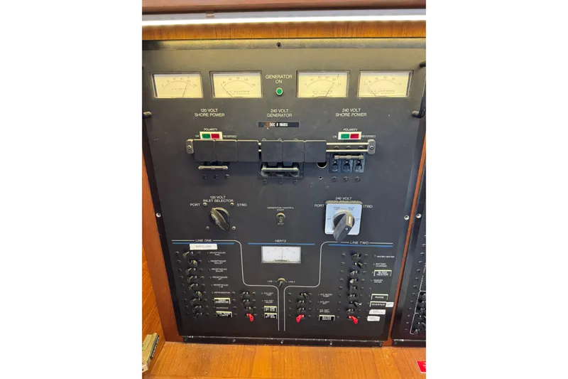 Slide: The Image of Electrical control panel of a 1991 Californian 55 Cockpit Motor Yacht, featuring gauges and switches. - 105