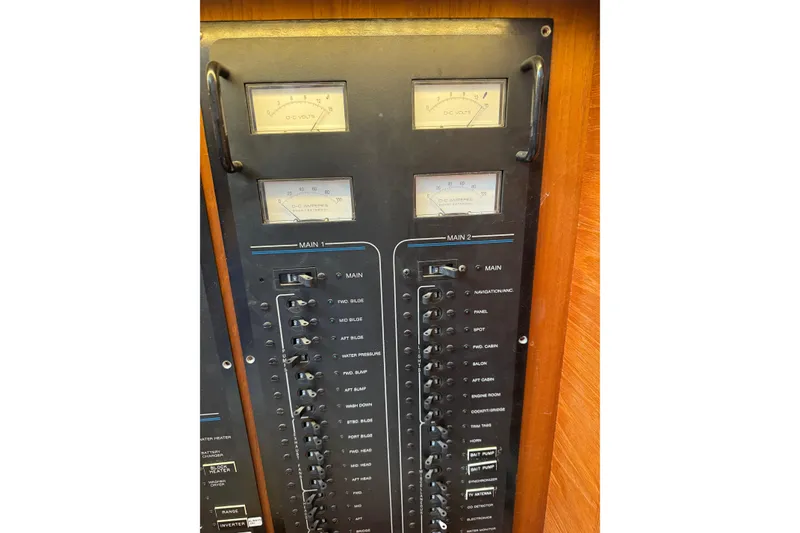 Slide: The Image of Electrical panel of a 1991 Californian 55 Cockpit Motor Yacht with gauges and switches. - 106