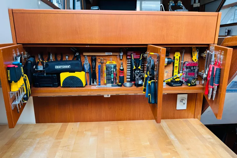 Slide: The Image of Tool storage on 1991 Californian 55 Cockpit Motor Yacht, featuring organized hand tools and accessories. - 107