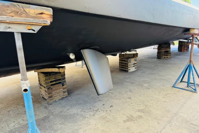 Slide: The Image of 1991 Californian 55 Cockpit Motor Yacht hull on dry dock with support stands. - 117