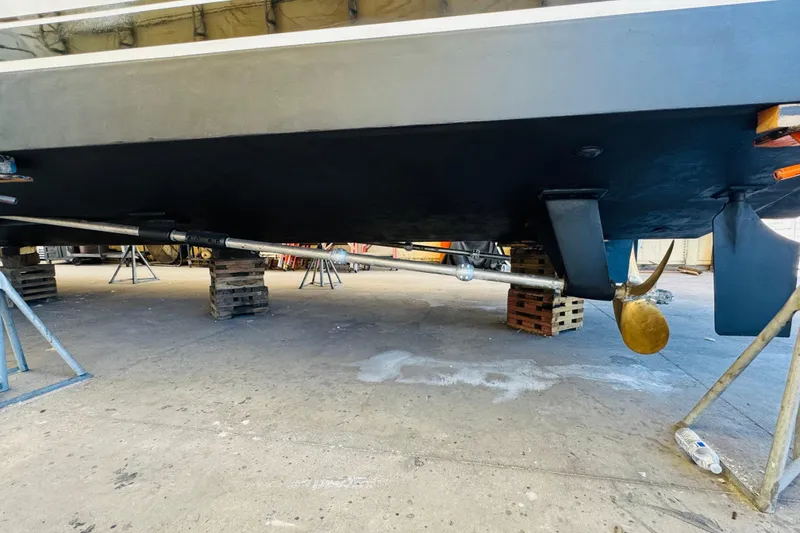 Slide: The Image of 1991 Californian 55 Cockpit Motor Yacht under maintenance, showing propeller and rudder. - 118