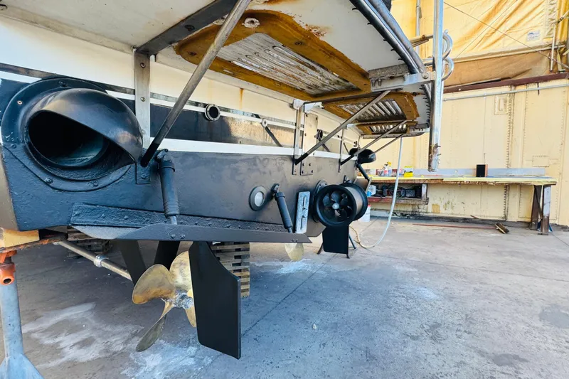 Slide: The Image of 1991 Californian 55 Cockpit Motor Yacht under maintenance, showcasing propeller and stern details. - 119