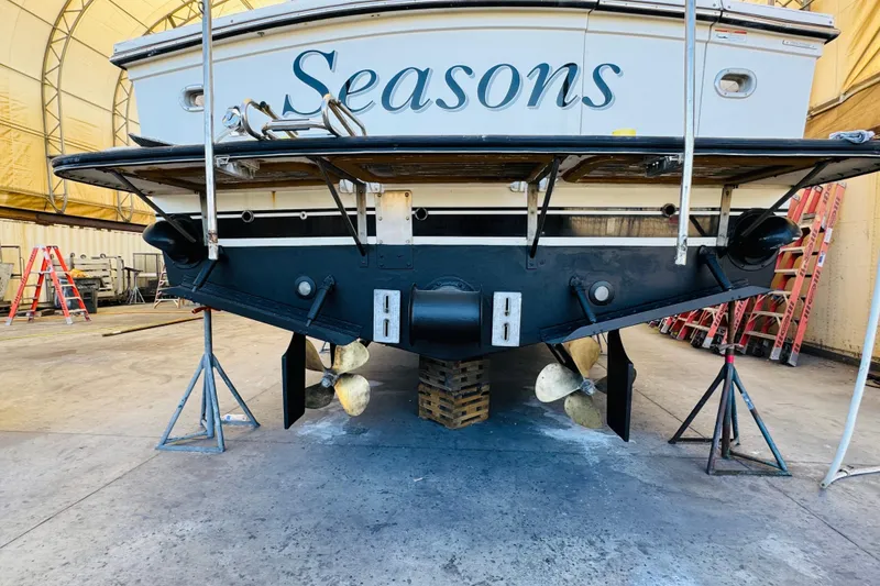 Slide: The Image of 1991 Californian 55 Cockpit Motor Yacht in dry dock, showcasing propellers and rudders. - 122