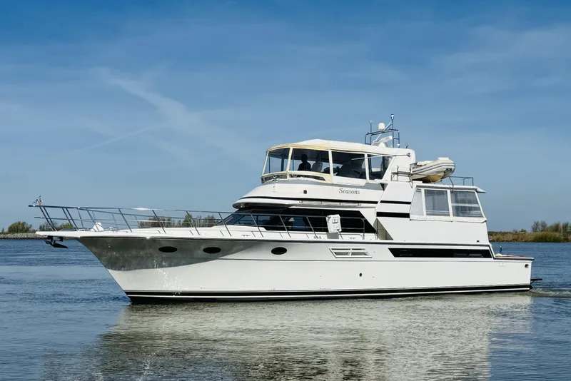 Slide: The Image of 1991 Californian 55 Cockpit Motor Yacht cruising on calm waters under clear skies. - 13