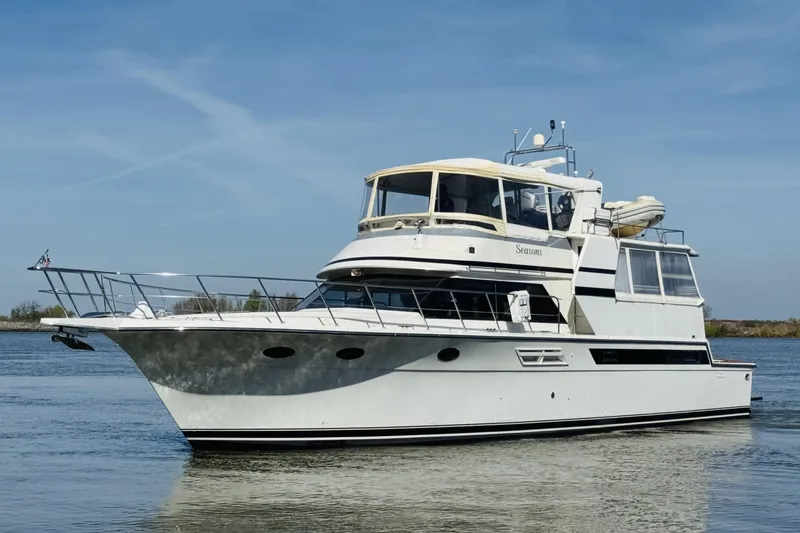 Slide: The Image of 1991 Californian 55 Cockpit Motor Yacht cruising on calm waters under clear skies. - 14