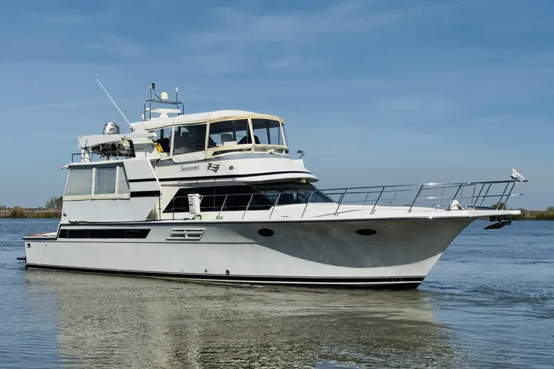 Slide: The Image of 1991 Californian 55 Cockpit Motor Yacht cruising on calm waters under clear skies. - 15