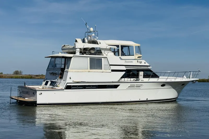 Slide: The Image of 1991 Californian 55 Cockpit Motor Yacht cruising on calm waters under a clear blue sky. - 17