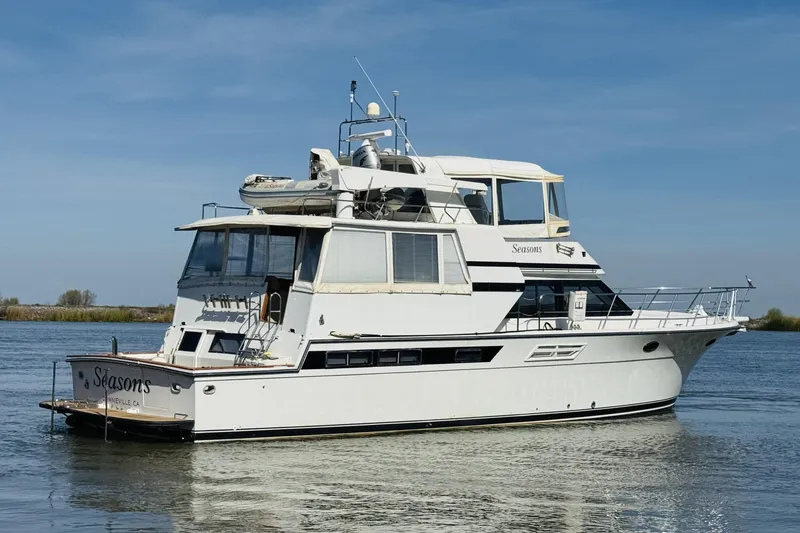 Slide: The Image of 1991 Californian 55 Cockpit Motor Yacht on calm water under clear blue sky. - 18