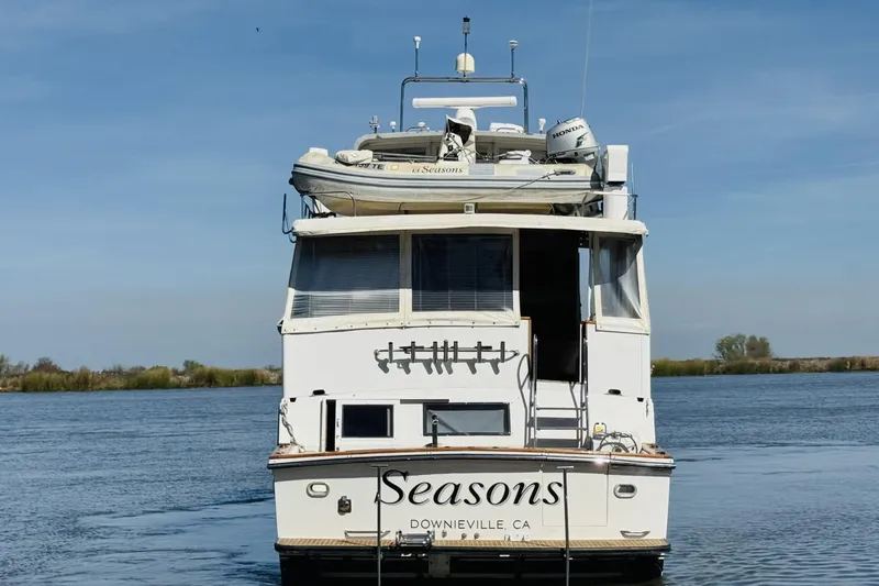Slide: The Image of 1991 Californian 55 Cockpit Motor Yacht on calm water, rear view. - 19