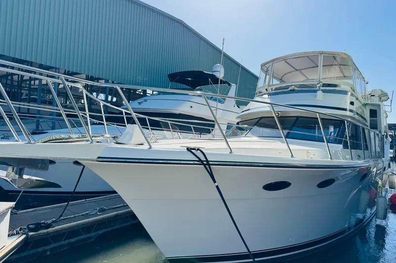 Slide: The Image of 1991 Californian 55 Cockpit Motor Yacht docked at marina, side view. - 20