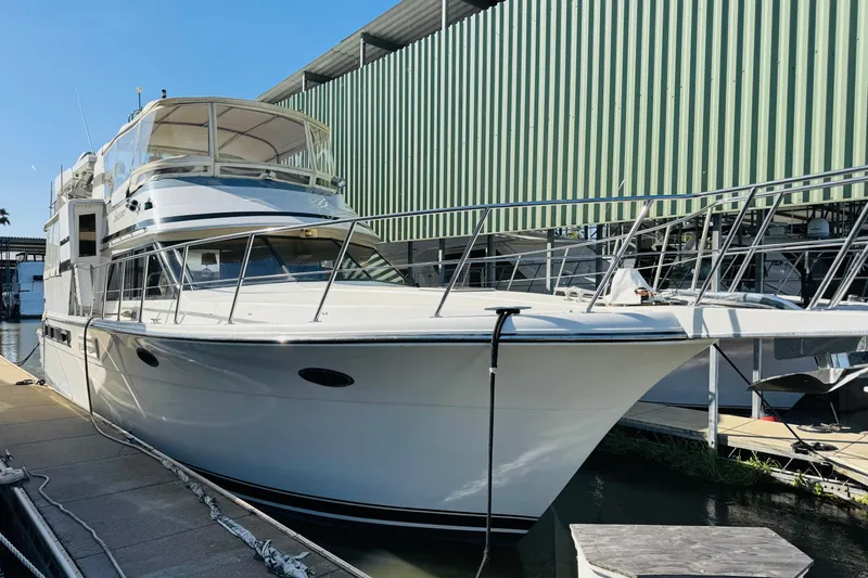 Slide: The Image of 1991 Californian 55 Cockpit Motor Yacht docked at marina under clear blue sky. - 21