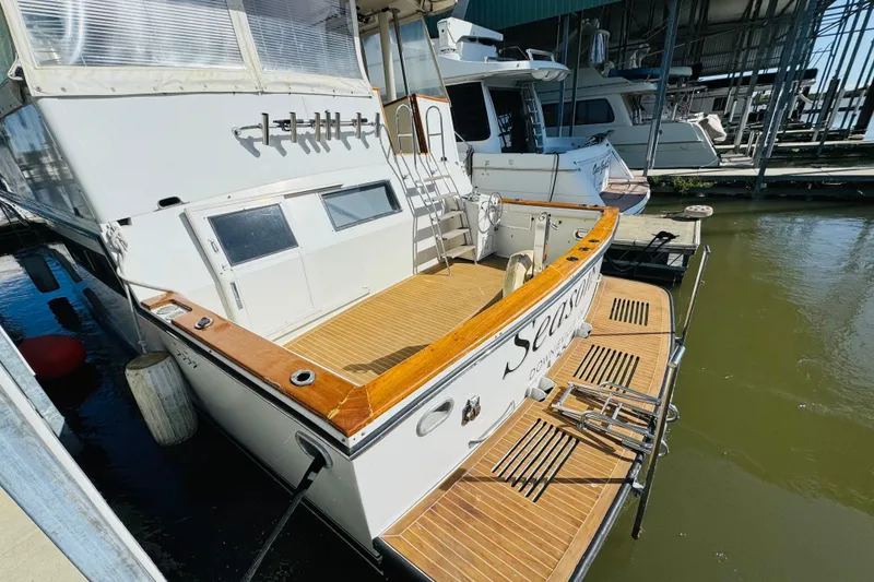 Slide: The Image of 1991 Californian 55 Cockpit Motor Yacht docked, featuring spacious deck and elegant design. - 25