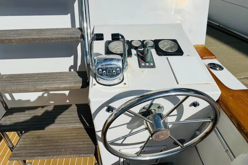 Slide: The Image of 1991 Californian 55 Cockpit Motor Yacht helm with steering wheel and controls. - 28