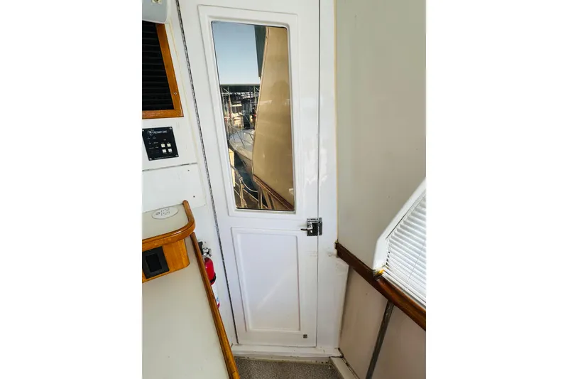 Slide: The Image of Interior view of 1991 Californian 55 Cockpit Motor Yacht with door and window. - 29