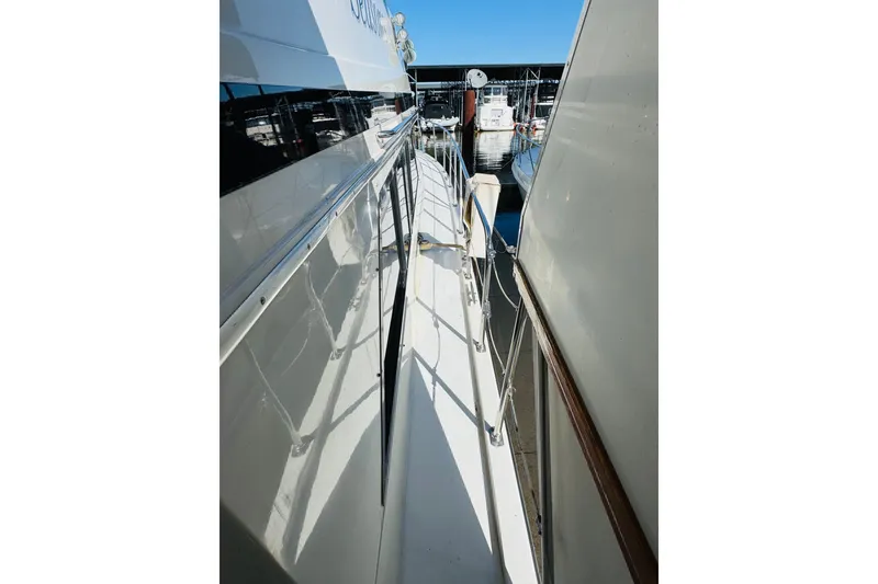 Slide: The Image of Side view of 1991 Californian 55 Cockpit Motor Yacht docked at marina. - 30