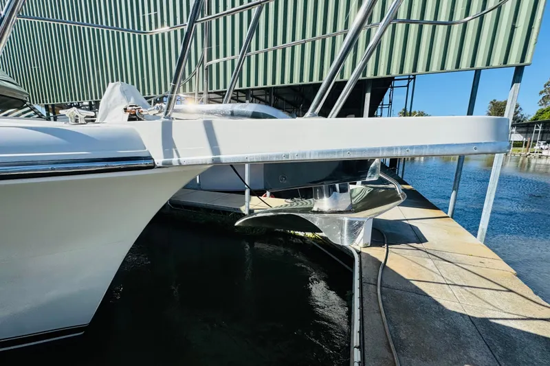 Slide: The Image of 1991 Californian 55 Cockpit Motor Yacht docked, showcasing sleek design and polished metalwork. - 32