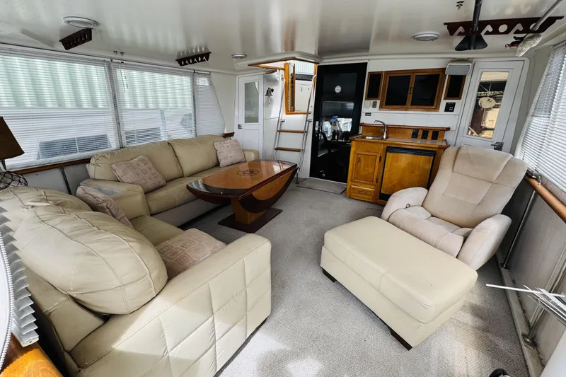 Slide: The Image of Luxurious interior of a 1991 Californian 55 Cockpit Motor Yacht with plush seating and wooden accents. - 33