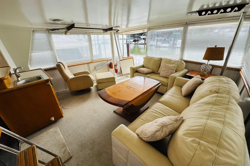 Slide: The Image of Luxurious interior of 1991 Californian 55 Cockpit Motor Yacht with plush seating and wooden accents. - 35