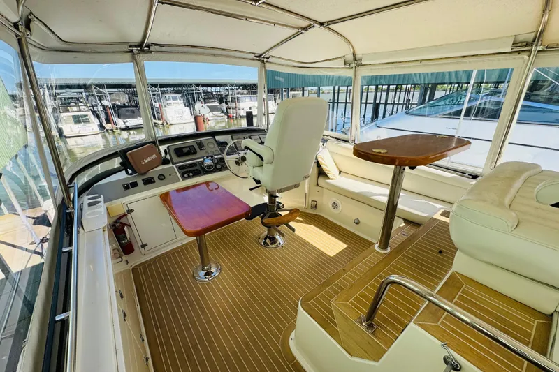 Slide: The Image of Interior of 1991 Californian 55 Cockpit Motor Yacht with helm and seating area. - 40