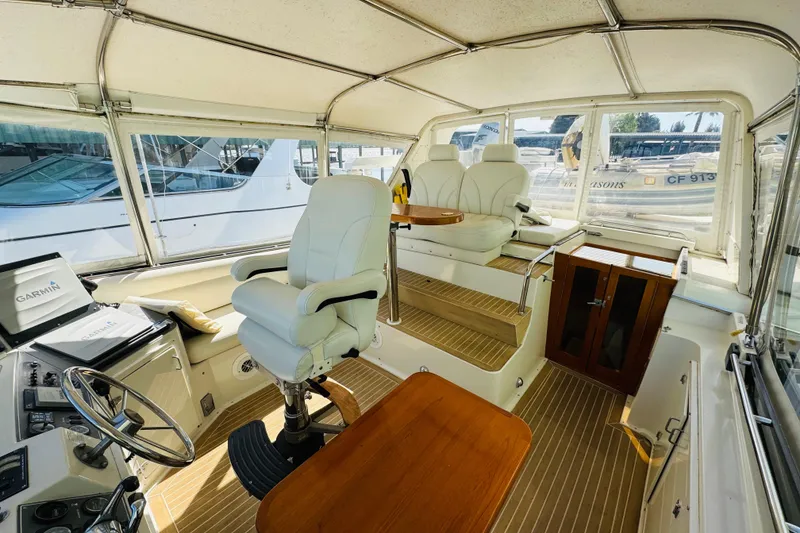 Slide: The Image of Interior of 1991 Californian 55 Cockpit Motor Yacht with helm and seating area. - 41
