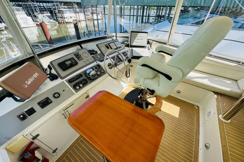 Slide: The Image of Cockpit of 1991 Californian 55 Cockpit Motor Yacht with steering wheel and navigation equipment. - 42