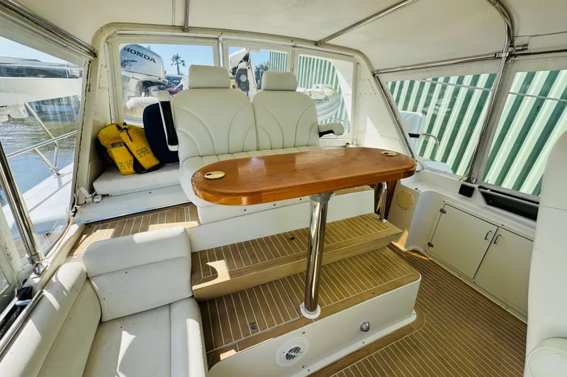 Slide: The Image of Interior of 1991 Californian 55 Cockpit Motor Yacht with seating and wooden table. - 45