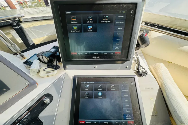 Slide: The Image of Cockpit of 1991 Californian 55 Motor Yacht with Garmin navigation screens and controls. - 49