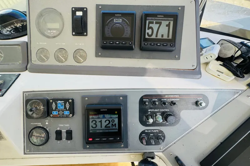 Slide: The Image of Control panel of a 1991 Californian 55 Cockpit Motor Yacht with navigation instruments. - 60