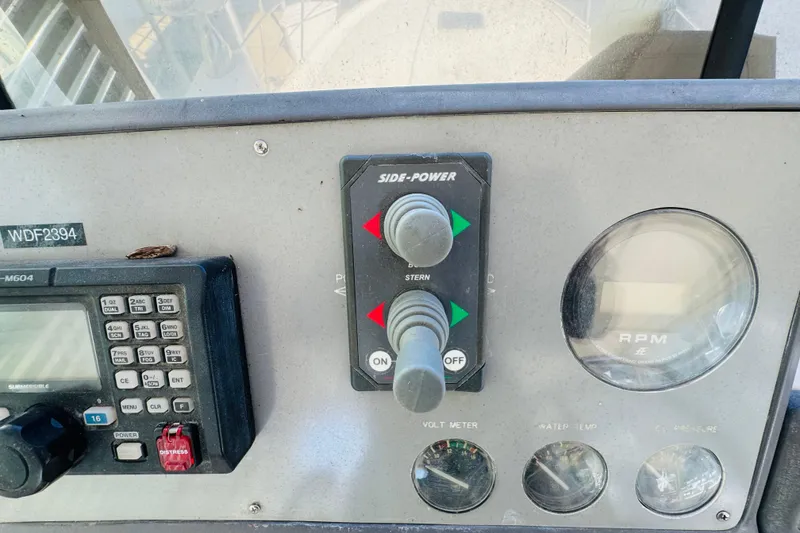 Slide: The Image of Control panel of a 1991 Californian 55 Cockpit Motor Yacht with navigation and RPM gauges. - 62