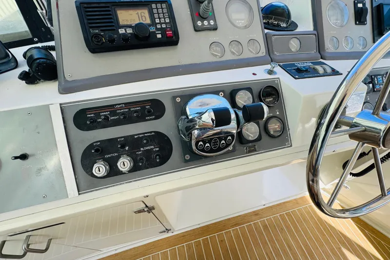 Slide: The Image of Control panel of a 1991 Californian 55 Cockpit Motor Yacht with steering wheel and gauges. - 64