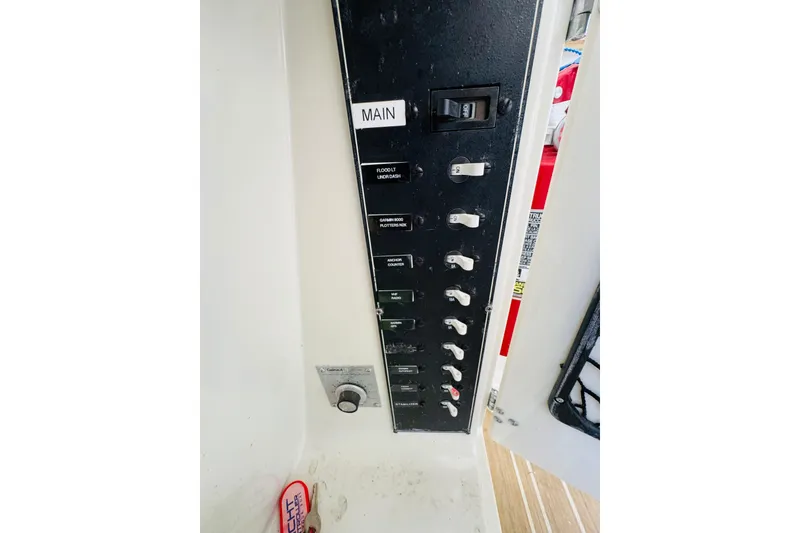 Slide: The Image of Control panel of a 1991 Californian 55 Cockpit Motor Yacht with labeled switches. - 67